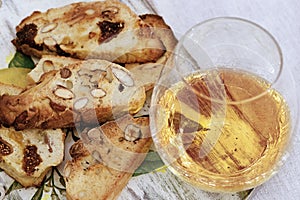 Biscotti cookies with sweet wine Vin Santo on wooden desk. Cup of wine, sweet wine and dessert biscotti
