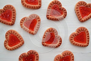 Biscuit in form of red hearts for gift card. Romantic bakery. Biscuit sweet cookie background