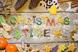 Biscuit letters and christmas decoration on wood, christmastime photo