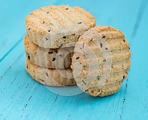 Biscuit with seasame on a blue wood