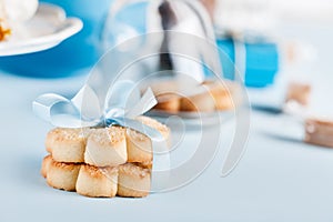 Biscuits with blue ribbon on blue background