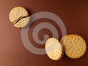 biscuits and broken biscuit , round biscuits on brown background