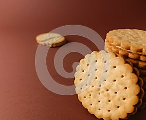 biscuits and broken isolated, round biscuits on brown background