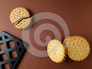 biscuits and broken isolated, round biscuits on brown background,close up