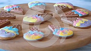 Biscuits with colorful glaze on wooden board.