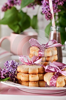 Biscuits with pink ribbon,lilac flowers and chocolate milkshake