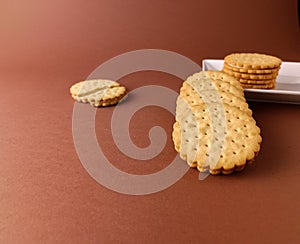 biscuits on white dish and isolated, round biscuits on brown background