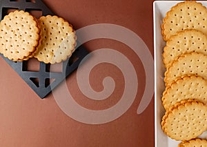 biscuits on white dish , round biscuits on brown background