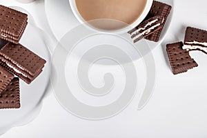 Biscuits on white plate and cup of coffee
