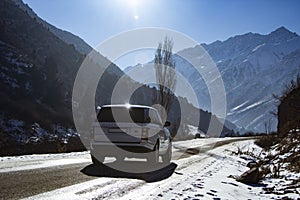 Bishkek, Kyrgyzstan - DEC 10, 2022: asphalt Road in Kyrgyzstan mountains with range rover car