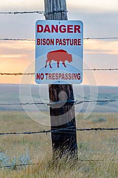 Bison crossing sign in a bison pasture near Swift Current, Saskatchewan photo