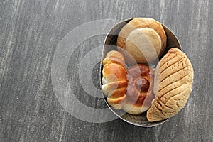 Sweet bread: Bisquet, croissant, Ojo de Pancha and Gusano freshly made from Mexican cuisine in a basket, or napkin accompanied by photo