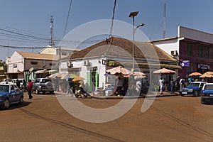 Street scene in the city of Bissau with people vendors selling vegetables and fish, in Guinea-Bissau.