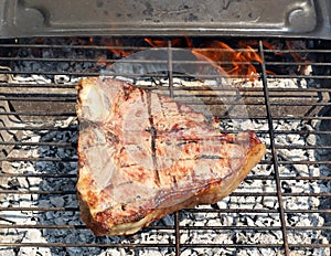 Bistecca Fiorentina, Florentine steak style in english, on the grill. photo