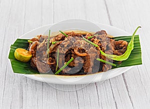 Bistek Tagalog Beef served in dish isolated on grey wooden background side view of fastfood photo