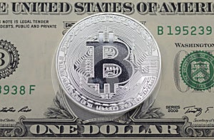 Bit coin lay on face side one dollar bill