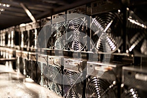 Bitcoin ASIC miners in warehouse. ASIC mining equipment on stand racks for mining cryptocurrency in steel container