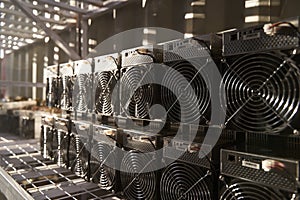 Bitcoin ASIC miners in warehouse. ASIC mining equipment on stand racks for mining cryptocurrency in steel container