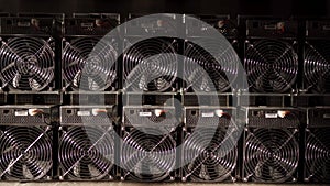 Bitcoin ASIC miners in warehouse. ASIC mining equipment on stand racks for mining cryptocurrency in steel container