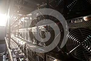 Bitcoin ASIC miners in warehouse. ASIC mining equipment on stand racks for mining cryptocurrency in steel container