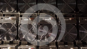 Bitcoin ASIC miners in warehouse. ASIC mining equipment on stand racks for mining cryptocurrency in steel container