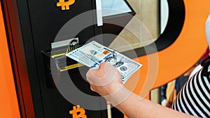 Bitcoin atm machine money. Usd hundred money payment on virtual crypto currency btc wallet. Woman withdraw american