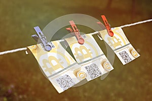 Bitcoin banknotes with clothespins