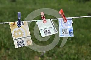 Bitcoin banknotes with clothespins