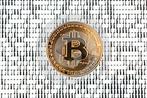 Bitcoin on binary code blurred background