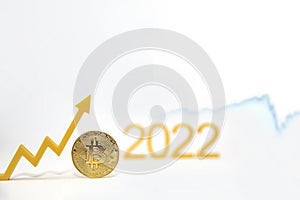 Bitcoin. Bitcoin price in 2022. Popular cryptocurrency rate. The Bitcoin coin on the price chart is pointing upwards