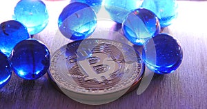 Bitcoin with blue marbles.