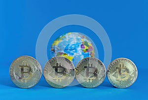 Bitcoin BTC crypto currency gold coins and Earth globe, worldwide new virtual money concept. Mining or blockchain technology