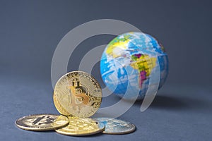 Bitcoin BTC crypto currency gold coins and Earth globe, worldwide new virtual money concept. Mining or blockchain technology