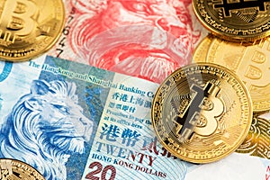 Bitcoin BTC Cryptocurrency coins and Hong Kong Dollar HKD currency banknotes. HKD BTC