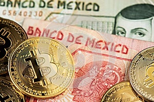 Bitcoin BTC Cryptocurrency coins and Mexican Pesos MXN currency banknotes.