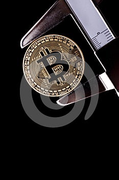 Bitcoin and calibre on black background photo