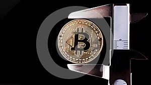 Bitcoin and calibre on black background photo