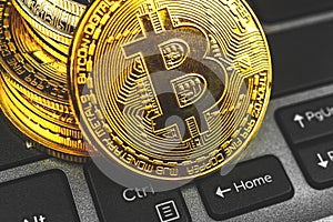 Bitcoin close-up view on a laptop keyboard, crypto currency background photo