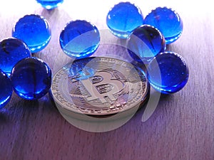 Bitcoin with blue glass marbles.