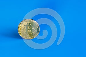 Bitcoin coin on a blue background. copy space