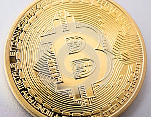 Bitcoin coin on brushed aluminium background