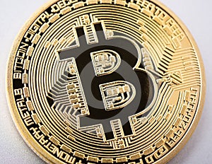 Bitcoin coin on brushed aluminium background