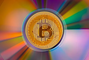 Bitcoin coin on a CD - DVD, background for design