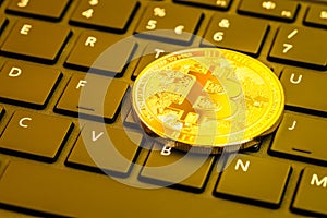 Bitcoin coin on computer keyboard