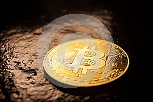 bitcoin coin on dark rock surface