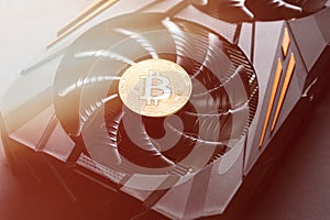 Bitcoin coin on a graphic card. Mining cryptocurrency