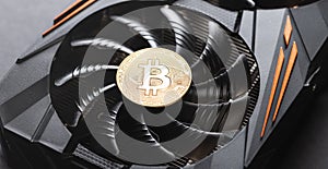 Bitcoin coin on a graphic card. Mining cryptocurrency