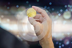 Bitcoin on a coin held by a hand. The is the leading cryptocurrency in the financial world is the favorite asset for invesment and