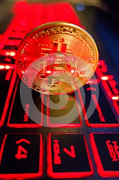 Bitcoin coin l on laptop keyboard