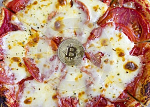 Bitcoin coin on pizza background, cryptocurrency rate concept